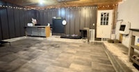 a room in a house with a fireplace and a kitchen
