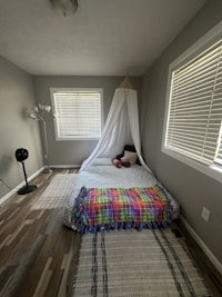 a small bedroom with a bed and a canopy
