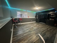 a basement with a bar and a television
